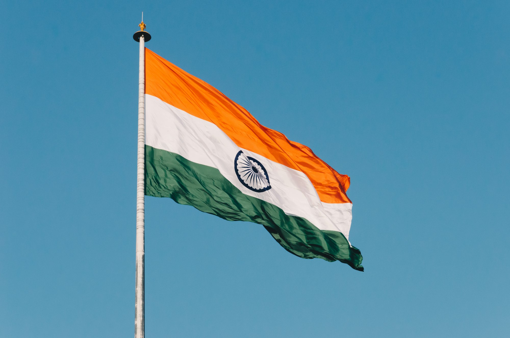 The Indian tricolour flag waving in the wind at the Wagah border near Amritsar in Punjab, India.