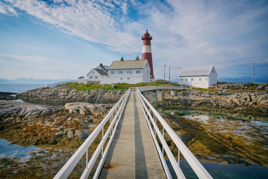 photo of suspension bridge towards into lighthouse during daytime in Tranøy Fyr Norway