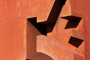 Metal art piece featuring geometric patterns and a rustic finish