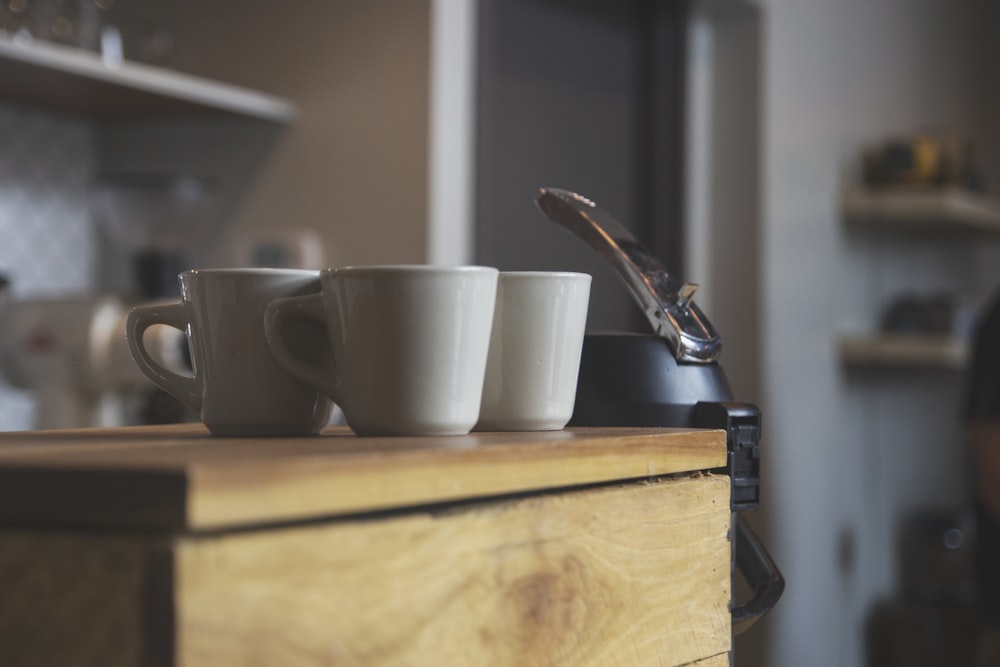 three white ceramic coffee mugs