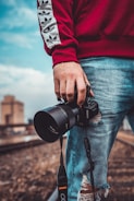person holding black Sony DSLR camera