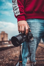 person holding black Sony DSLR camera