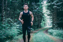 man walking on forest trail