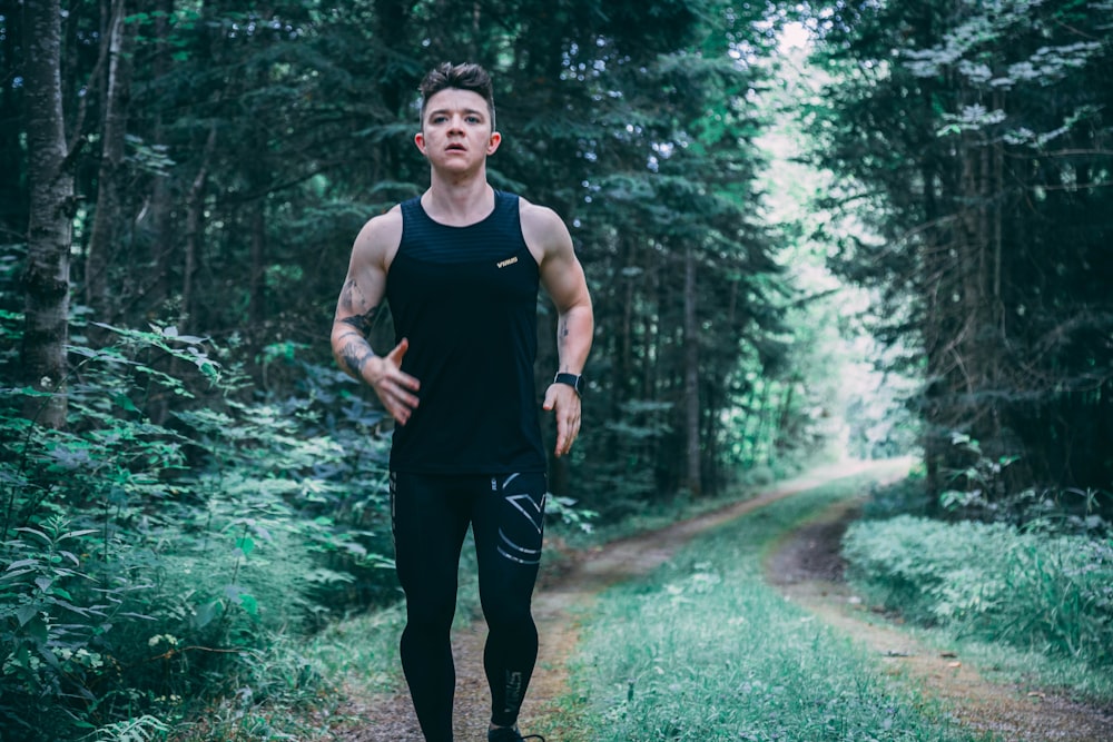 man walking on forest trail