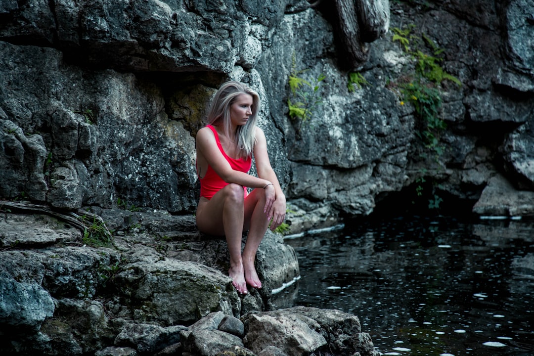 woman sitting on rocks