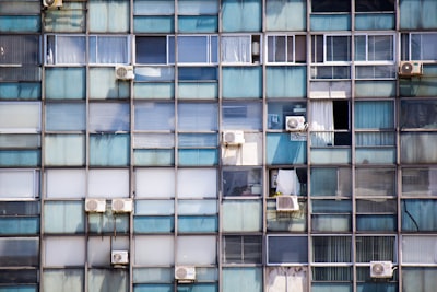 blue painted building with window-type air conditioners uruguay teams background