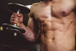 man holding black dumbbell