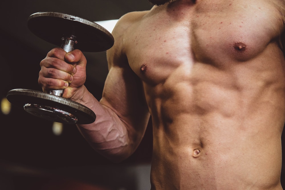 man holding black dumbbell