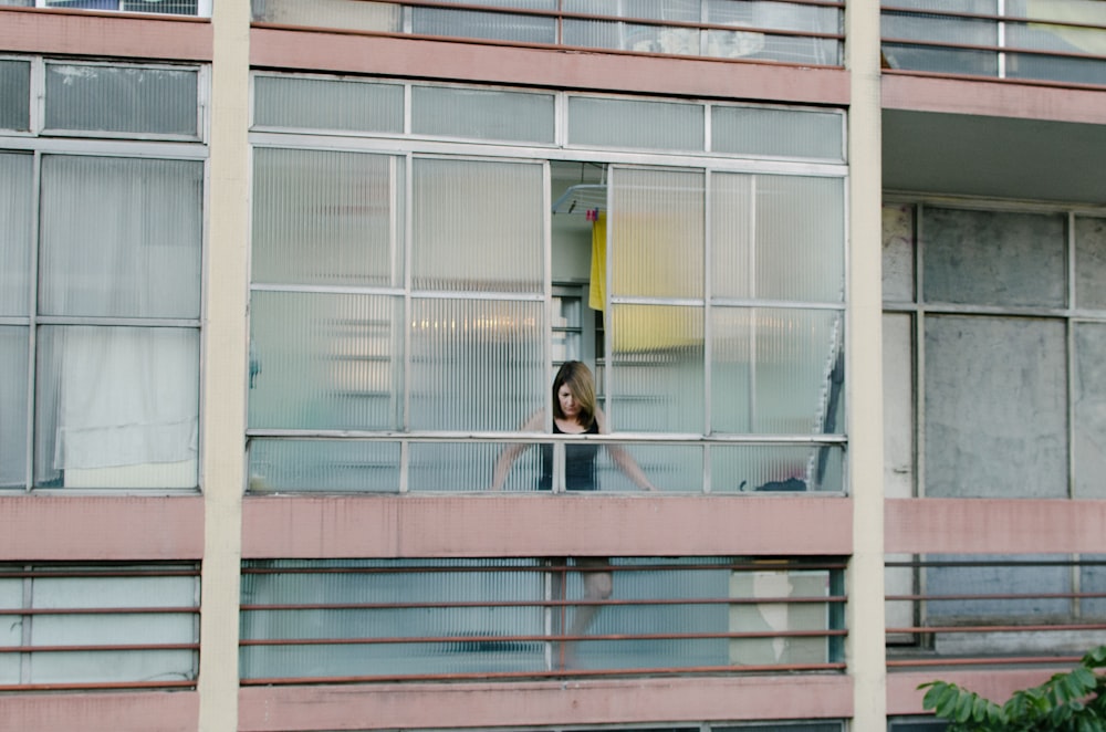 woman looking thru windows