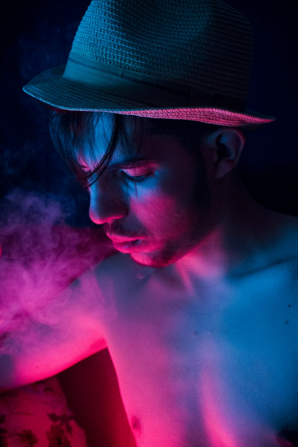 photograph of topless man with brown hat