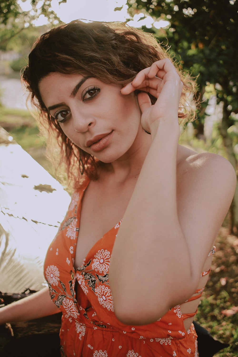 woman wearing red floral sleeveless dress