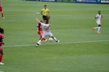 A referee signaling a decision during a fast-paced soccer match.
