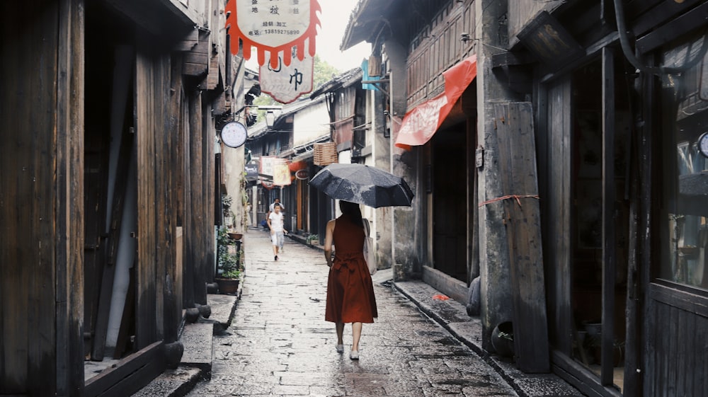 woman holding black umbrella