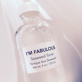 A close-up view of a transparent bottle with a white cap, labeled I’M FABULOUS Seaweed Toner. The bottle appears to contain a clear liquid, and the label also states that the toner is seaweed-based and has a net weight of 4 oz / 120 mL.