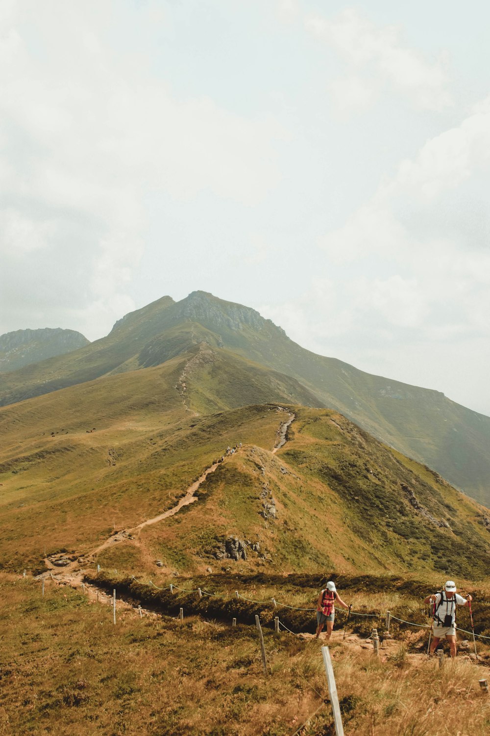 two men walking on mountain peak