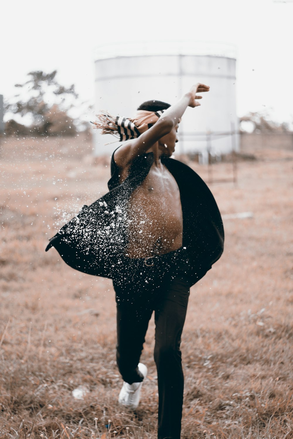 man spin with splash of white powder