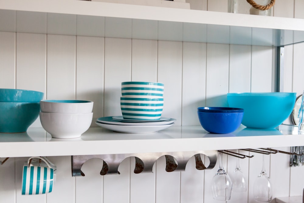 assorted ceramic food bowls on white shelf
