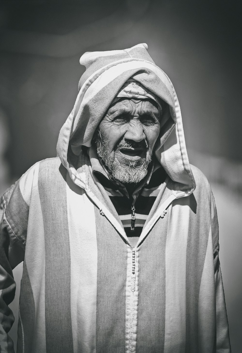 grayscale photo of man in hoodie