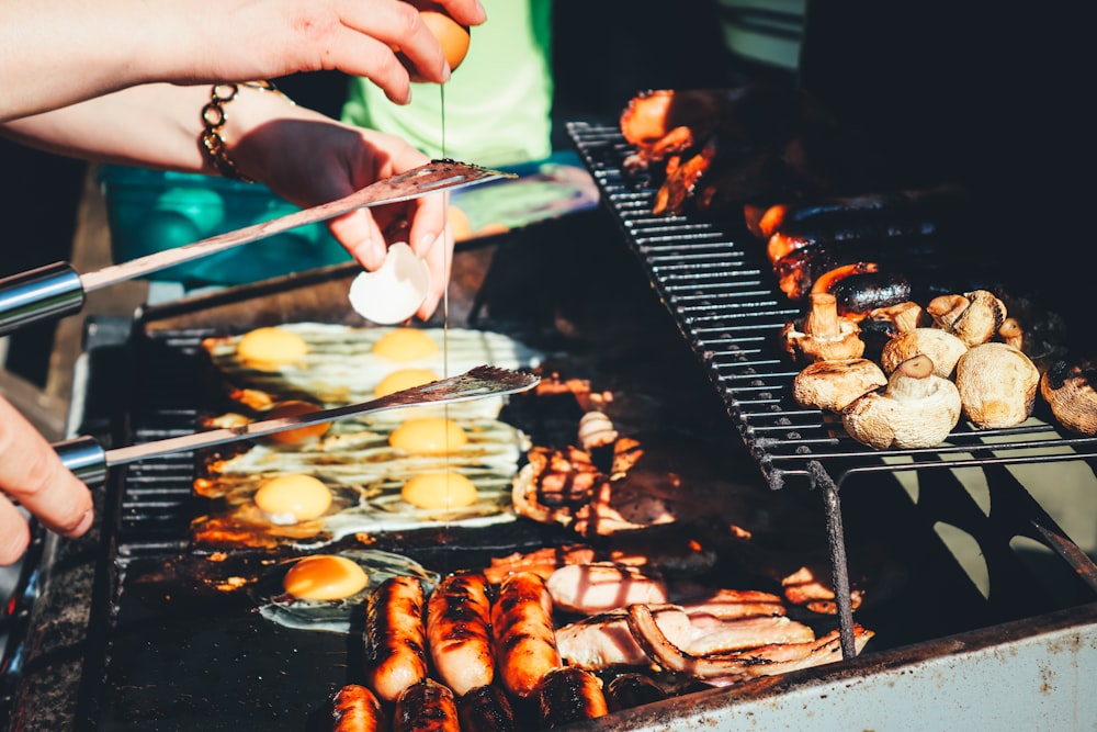 person holding tong with grilled food