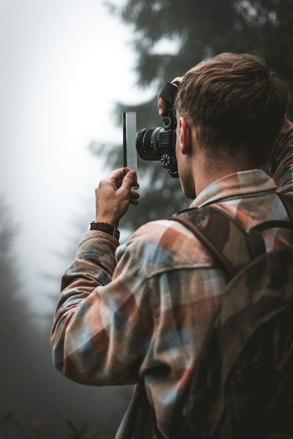 man taking photography outdoors