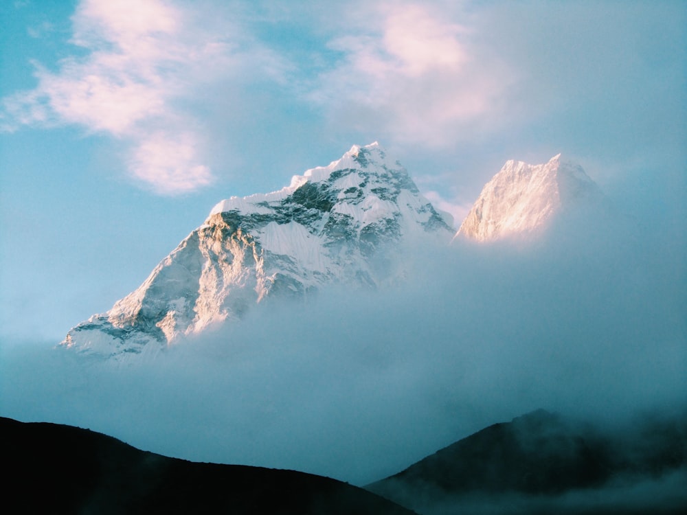 white snow-capped mountain with fog