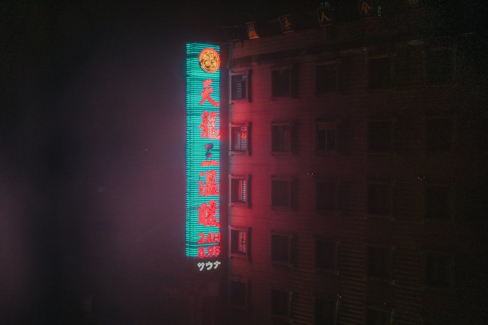 green signage mounted on concrete building