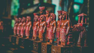 A joyful group of participants proudly holding their finished wooden carvings.