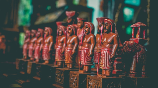 Close-up of intricately carved wooden figurines showcasing traditional Indian craftsmanship.