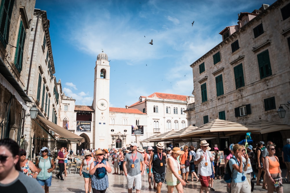 group of people standing surrounded by buildings