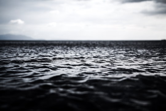 grayscale photography of rippling body of water in Lemery Philippines