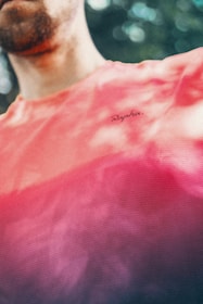 Close-up of a vibrant custom-printed t-shirt with splashes of cyan and magenta ink.