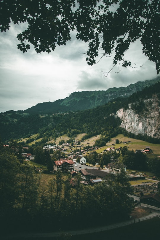 white concrete house near mountain peak in Staubbach Waterfall Switzerland