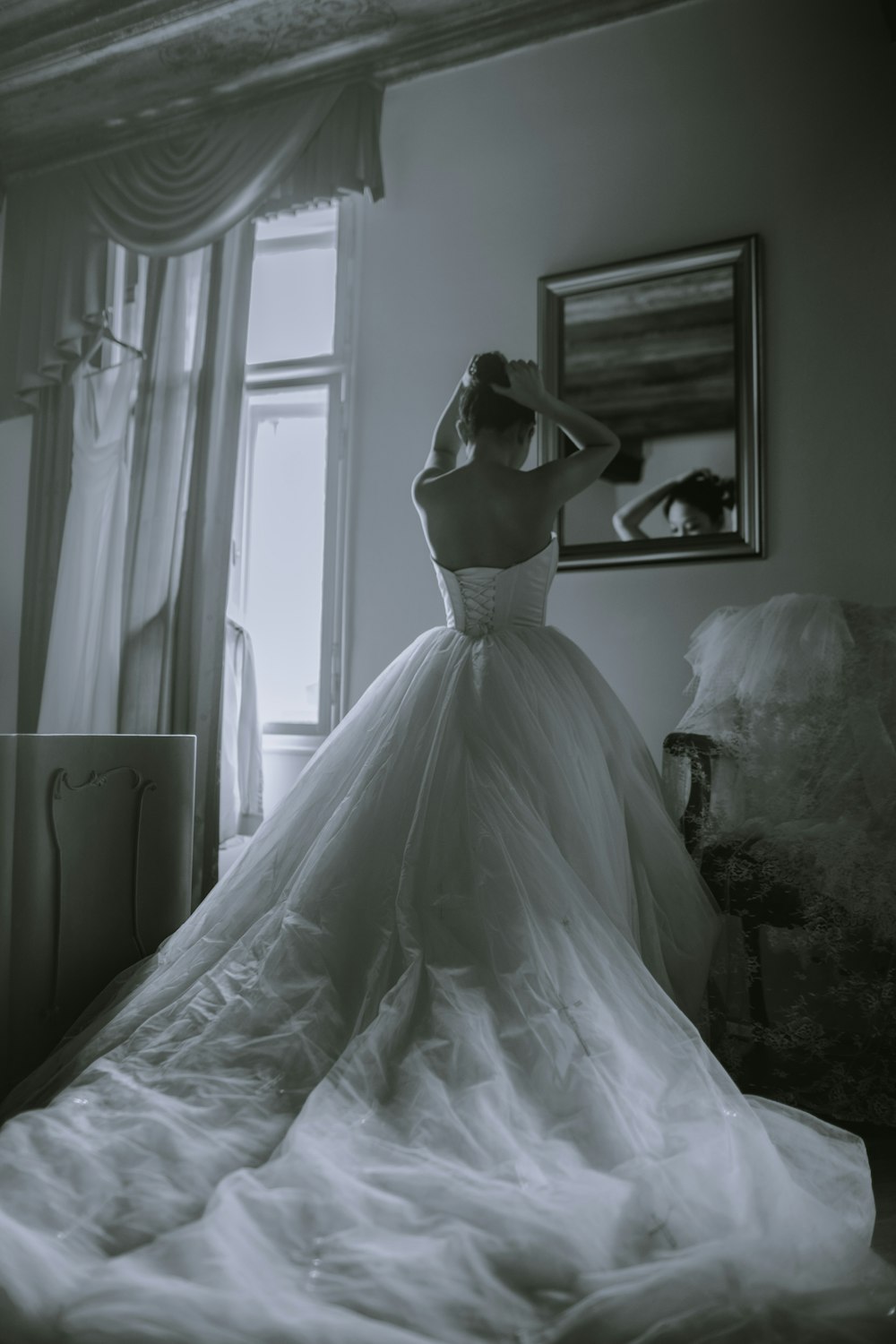 grayscale photo of woman facing on mirror