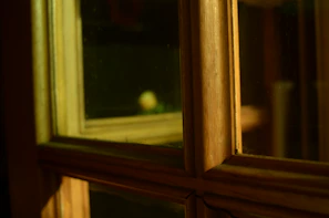 Evening light casting warm shadows inside a cozy homestay room.
