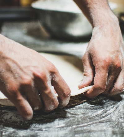 a person is kneading dough on a table