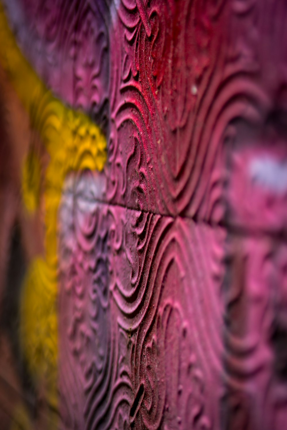 a close up of a wall with a colorful design on it