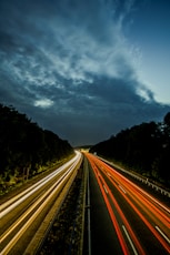 a long exposure photo of a highway at night