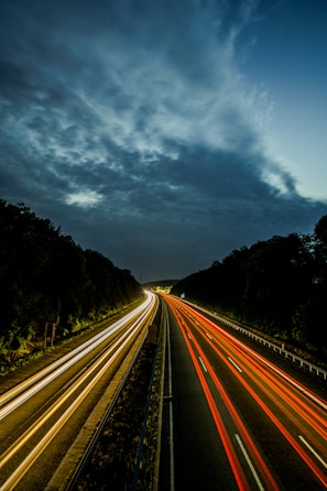 a long exposure photo of a highway at night