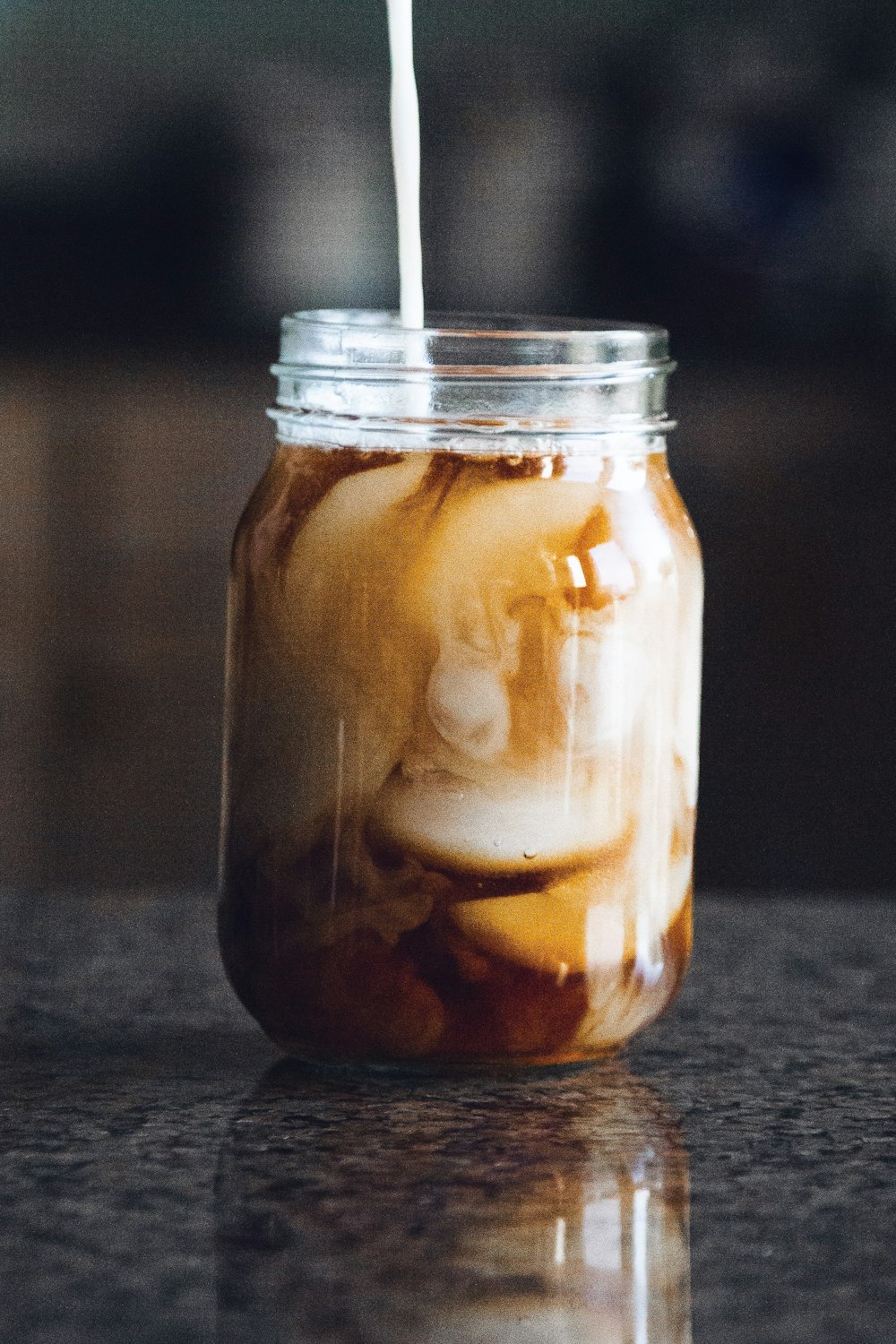 liquid filled mason jar on gray granite top