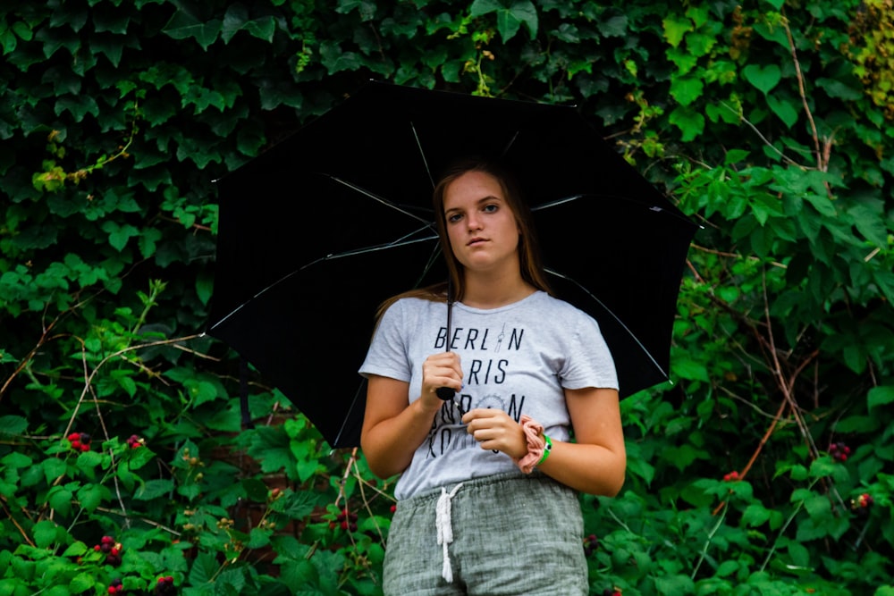 woman posing under black umbrella