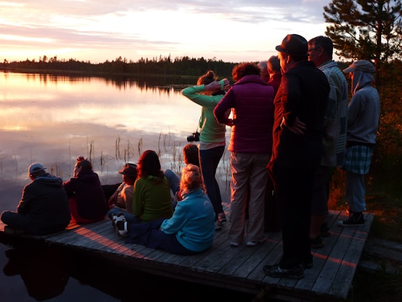 Friends gathered on the dock sharing stories and laughter as the sun sets.