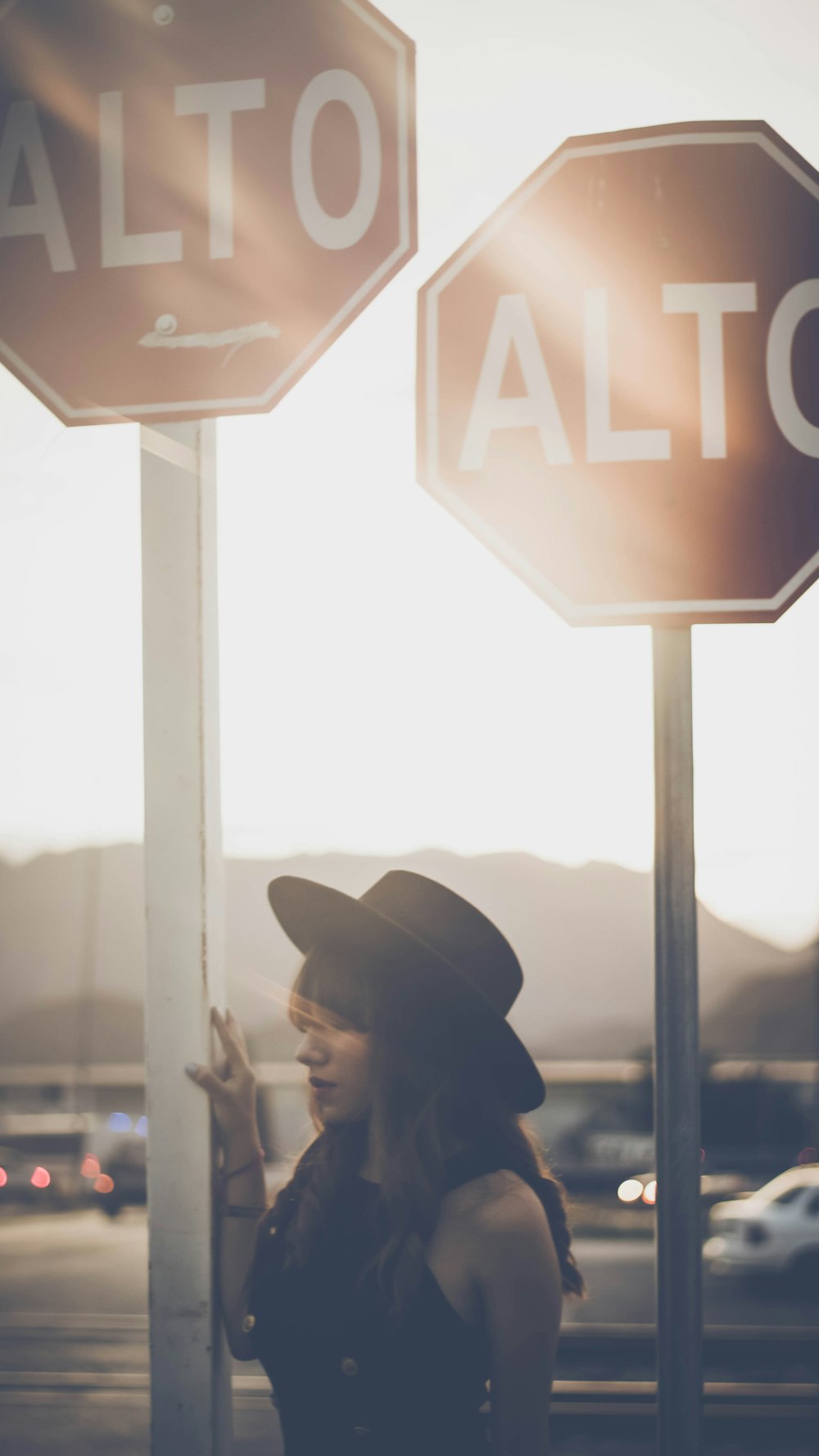 woman holding Alto street post at golden hour