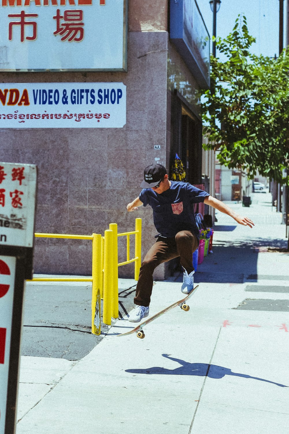 man in blue shirt skateboarding on gray surface