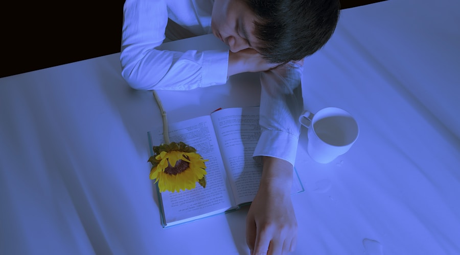 man in white dress shirt leaning on table beside book and mug