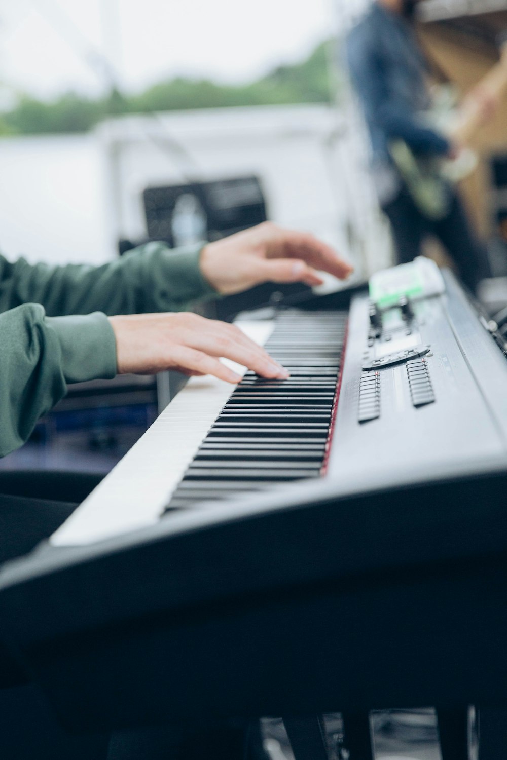 man playing black and white electronic keyboard