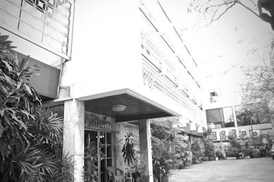 Historic black and white photo of Navashakti Herbals Hospital facade from decades ago