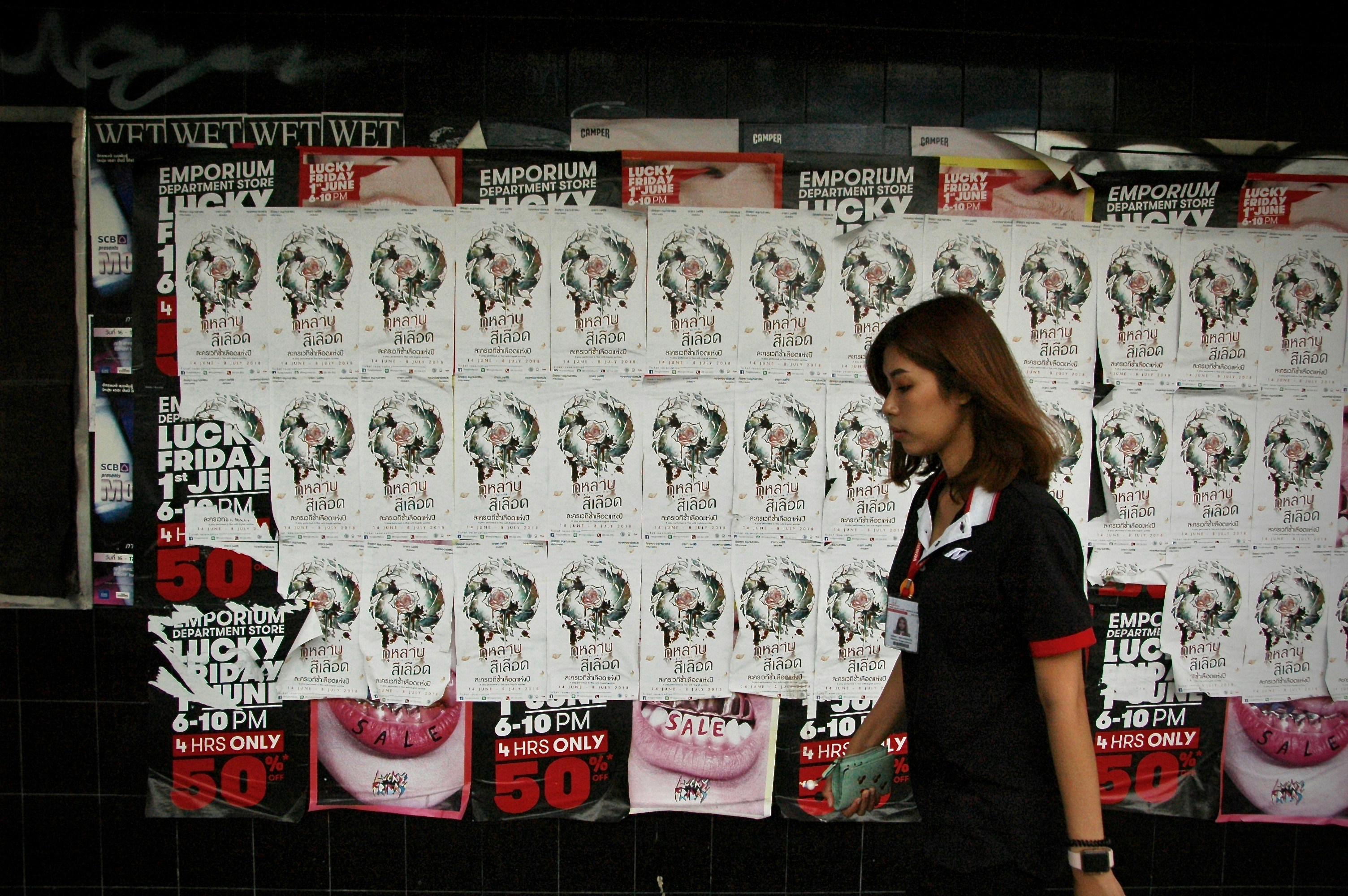 man walking beside white and black wall