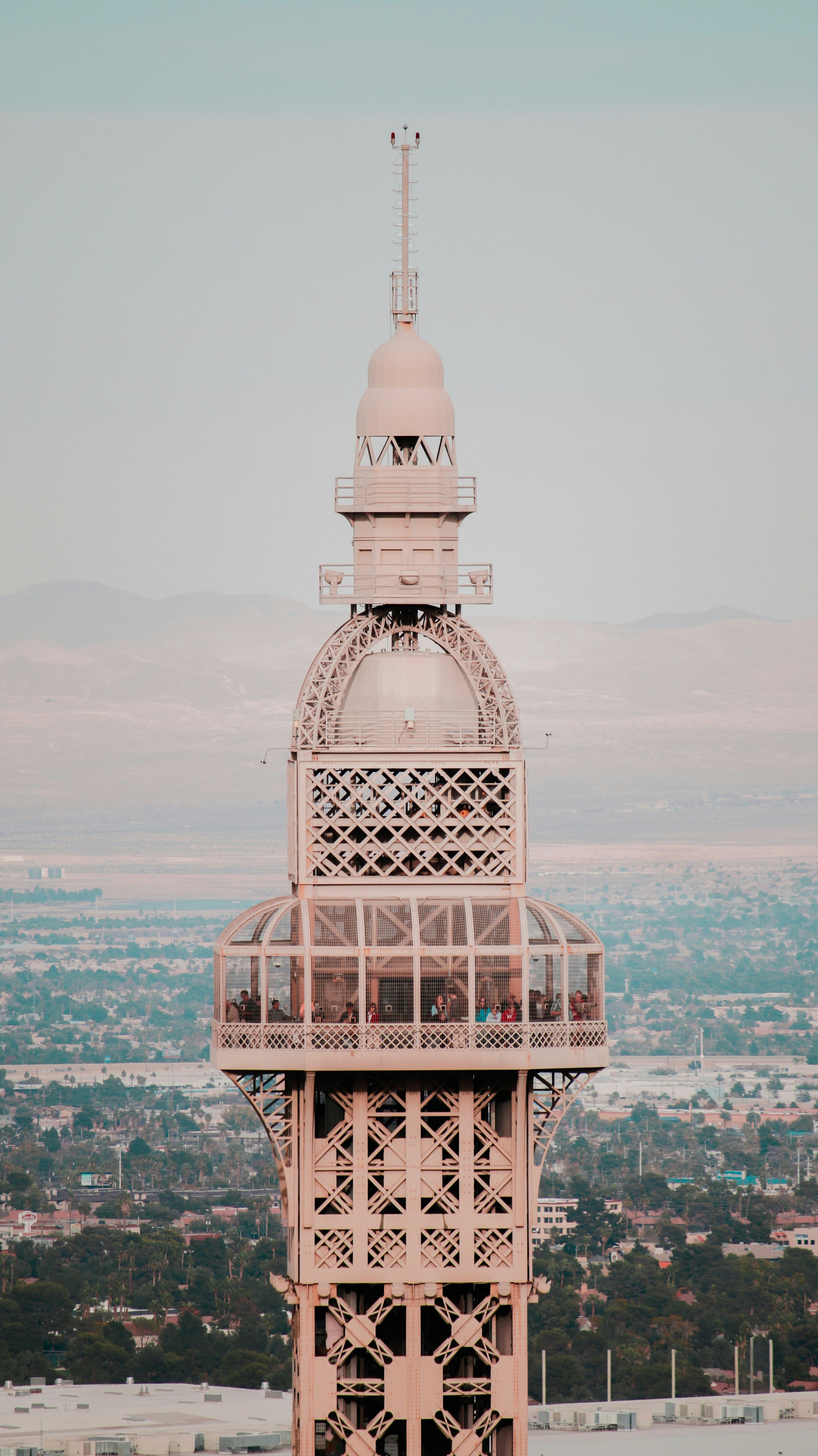 beige concrete tower under white clouds and blue sky at daytime