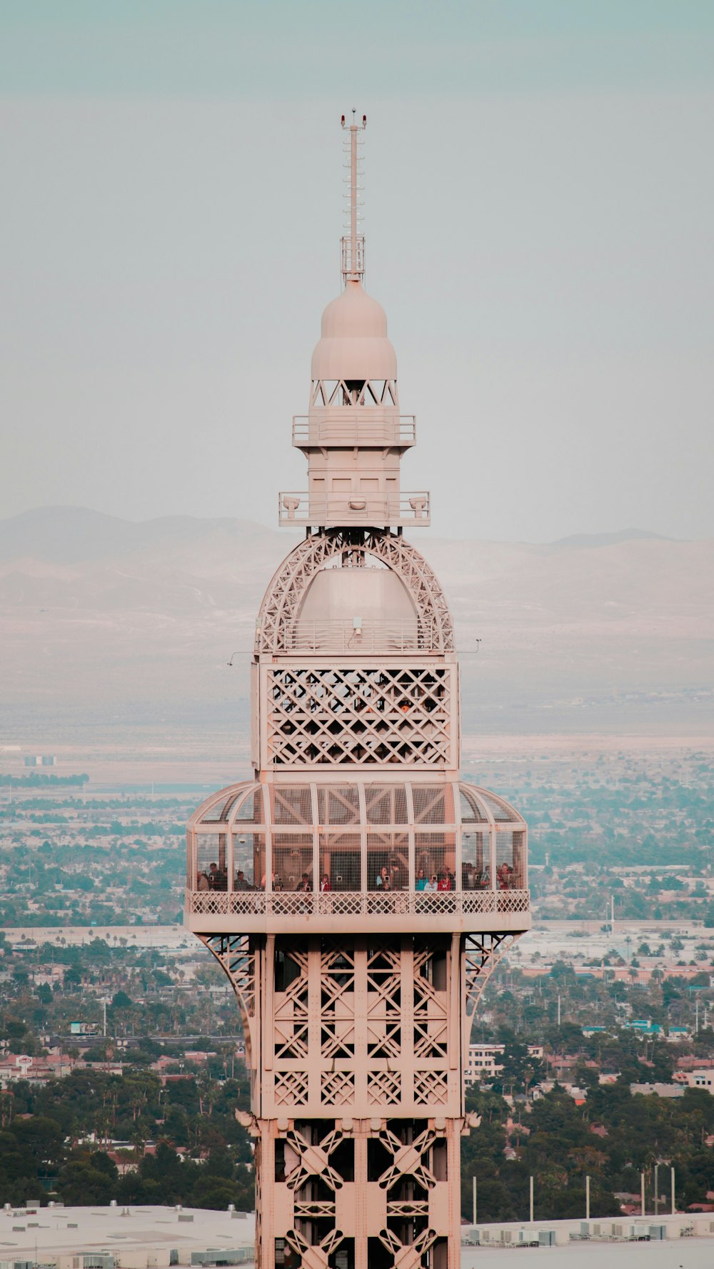 beige concrete tower under white clouds and blue sky at daytime