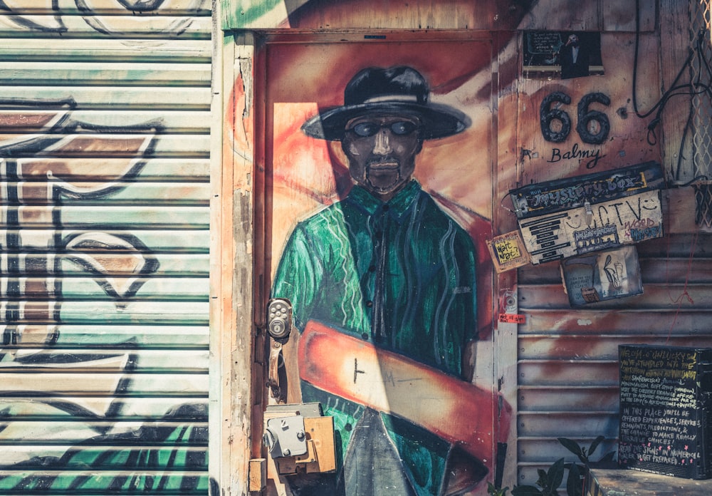 man wearing green polo painting